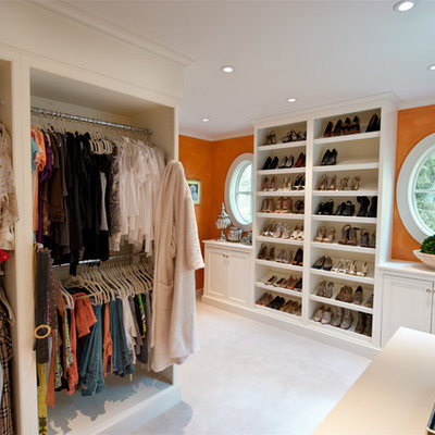 Elegant women's carpeted dressing room photo in Philadelphia with open cabinets and white cabinets