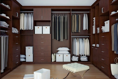 Photo of a large traditional walk-in wardrobe for men in Other with flat-panel cabinets, dark wood cabinets, light hardwood flooring and brown floors.