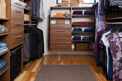 Walk-in closet - mid-sized walk-in closet idea in Toronto with flat-panel cabinets and medium tone wood cabinets