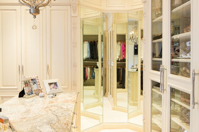 Inspiration for a mid-sized timeless women's carpeted walk-in closet remodel in St Louis