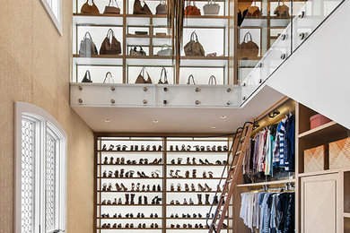 Example of a mountain style women's carpeted walk-in closet design in Phoenix with open cabinets