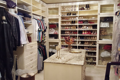 Photo of a large traditional gender neutral walk-in wardrobe in Chicago with recessed-panel cabinets, white cabinets and ceramic flooring.