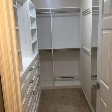 His and Hers Walk-in Closets with wainscott backing and other closets
