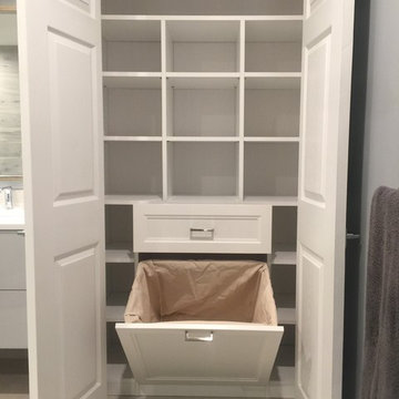 His and Hers Walk-in Closets with wainscott backing and other closets