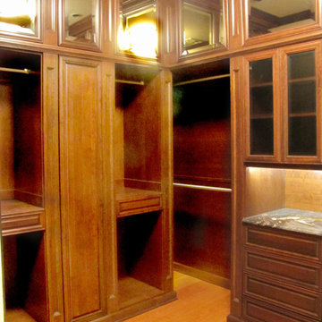 His master closet in wood with fluted columns and granite counters.  This closet