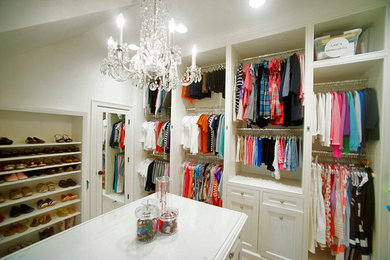 Mid-sized elegant women's carpeted walk-in closet photo in Houston with recessed-panel cabinets and white cabinets