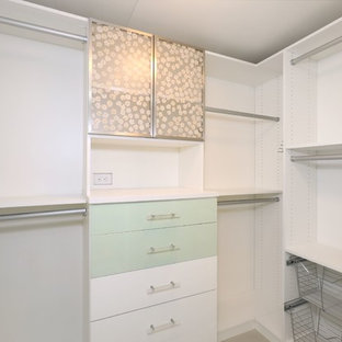 Mid-sized trendy light wood floor and brown floor walk-in closet photo in Orange County with flat-panel cabinets and green cabinets