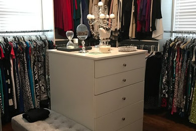 Dressing room - large modern women's medium tone wood floor dressing room idea in Birmingham with flat-panel cabinets and white cabinets