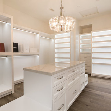 Large Master Closet with White Shelves and Cabinets