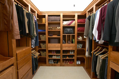 Walk-in closet - large traditional gender-neutral ceramic tile and beige floor walk-in closet idea in St Louis with flat-panel cabinets and medium tone wood cabinets