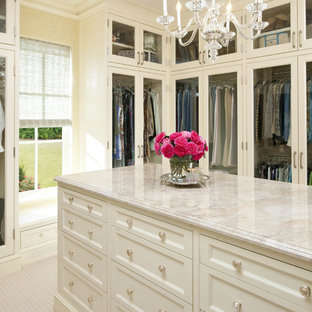 Elegant walk-in closet photo in Dallas with white cabinets