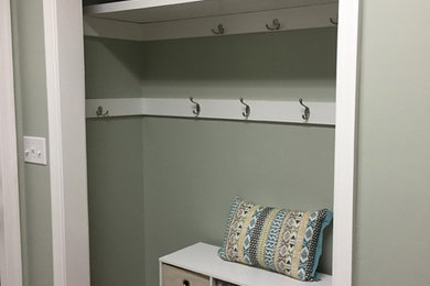 Small beach style gender-neutral medium tone wood floor reach-in closet photo in Jacksonville with open cabinets and white cabinets