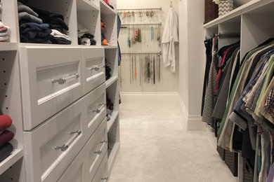 Example of a mid-sized transitional gender-neutral carpeted and white floor walk-in closet design in Montreal with shaker cabinets and white cabinets