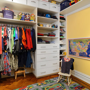 Inspiration for a huge timeless men's medium tone wood floor walk-in closet remodel in New York with flat-panel cabinets and white cabinets