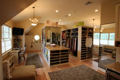 Inspiration for a huge gender-neutral light wood floor walk-in closet remodel in Philadelphia with raised-panel cabinets and beige cabinets