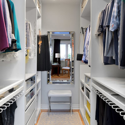 Example of a small transitional gender-neutral bamboo floor and beige floor walk-in closet design in Toronto with open cabinets and white cabinets
