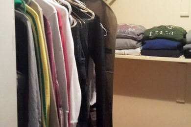 This is an example of a medium sized walk-in wardrobe in Toronto.