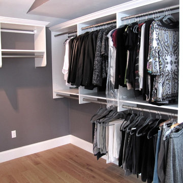 Master bedroom walk-in closet with pull-out ironing board, plenty of drawe