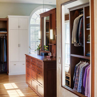 Large transitional medium tone wood floor dressing room photo in Boston with flat-panel cabinets and dark wood cabinets