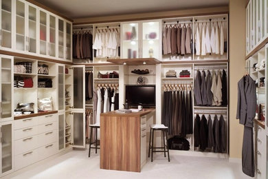 Large contemporary gender neutral walk-in wardrobe in Newark with open cabinets, white cabinets and carpet.