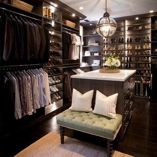 Idee per un ampio spazio per vestirsi unisex con ante in stile shaker, ante in legno bruno e parquet scuro