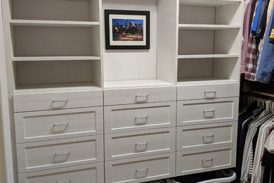 Example of a mid-sized trendy gender-neutral carpeted and gray floor walk-in closet design in Other with shaker cabinets and light wood cabinets