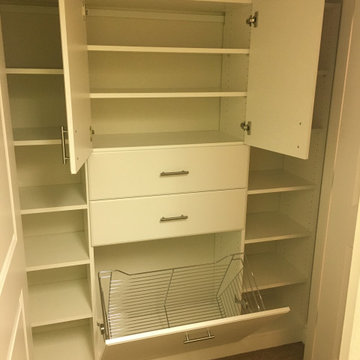 Master closet in white with hamper drawers & doors