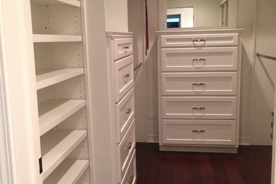 Walk-in closet - mid-sized traditional gender-neutral dark wood floor and brown floor walk-in closet idea in Other with shaker cabinets and white cabinets