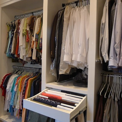 Example of a mid-sized transitional gender-neutral dark wood floor dressing room design in Indianapolis with white cabinets and open cabinets