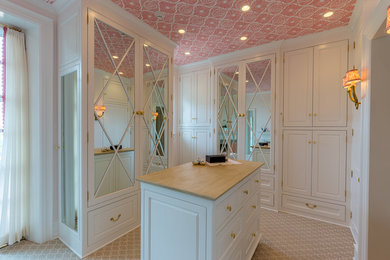 Example of a classic women's carpeted and beige floor walk-in closet design in Philadelphia with white cabinets