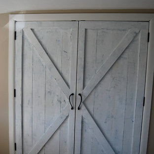 Inspiration for a large country gender-neutral medium tone wood floor reach-in closet remodel in Burlington with raised-panel cabinets and white cabinets