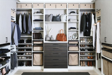 Walk-in closet - contemporary gender-neutral light wood floor and beige floor walk-in closet idea in Dallas with open cabinets and brown cabinets