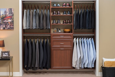 Mid-sized elegant gender-neutral carpeted reach-in closet photo in Orange County with open cabinets and dark wood cabinets