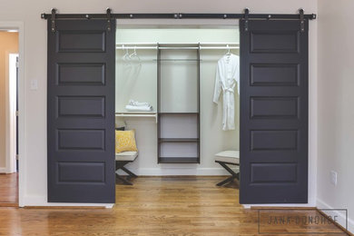 Example of a mid-sized transitional women's dark wood floor walk-in closet design in Raleigh