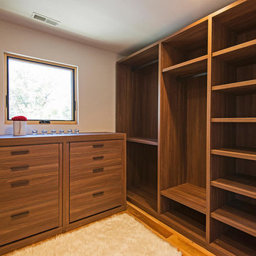 Modern Closet Featuring Poliform Shelving and Dresser with Leather Pulls