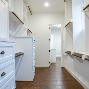 Inspiration for a large country gender-neutral medium tone wood floor and brown floor walk-in closet remodel in Dallas with shaker cabinets and white cabinets
