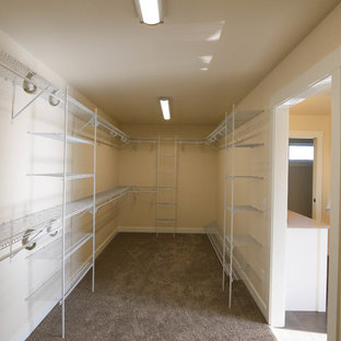Large country carpeted walk-in closet photo in Other