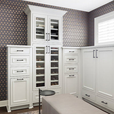 Example of a large transitional gender-neutral dark wood floor dressing room design in Minneapolis with recessed-panel cabinets and white cabinets