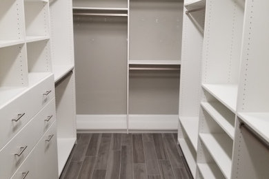 Inspiration for a walk-in closet remodel in Miami with flat-panel cabinets and white cabinets
