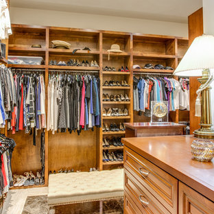 Large transitional women's marble floor and white floor dressing room photo in Austin with raised-panel cabinets and medium tone wood cabinets