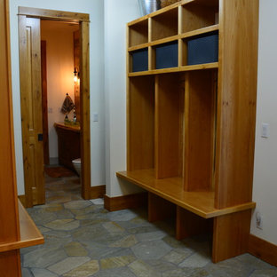 Esempio di una grande cabina armadio unisex stile rurale con ante marroni, pavimento in pietra calcarea e pavimento multicolore