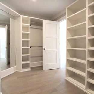 Idéer för stora funkis walk-in-closets för könsneutrala, med öppna hyllor, vita skåp, ljust trägolv och beiget golv