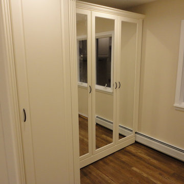 New White Walk Closet ft. Hardwood Floors and Mirrored Door
