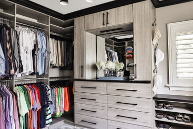 Modelo de armario vestidor de hombre contemporáneo con armarios con paneles lisos, puertas de armario grises, moqueta y suelo gris