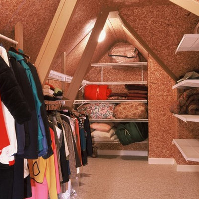 Walk-in closet - mid-sized traditional gender-neutral carpeted walk-in closet idea in Atlanta with open cabinets and white cabinets