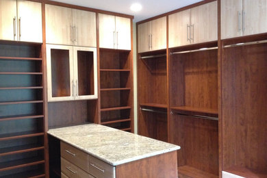 Large trendy gender-neutral carpeted dressing room photo in Other with open cabinets and dark wood cabinets