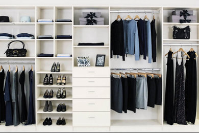 Dressing room - large transitional gender-neutral dressing room idea in Minneapolis with flat-panel cabinets and white cabinets