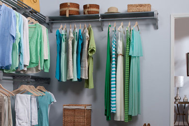 Example of a large transitional gender-neutral carpeted dressing room design in Miami with open cabinets