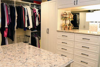 Inspiration for a large transitional gender-neutral carpeted dressing room remodel in Chicago with white cabinets and raised-panel cabinets