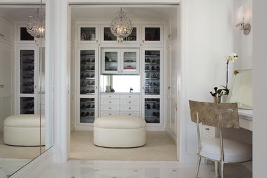Inspiration for a large transitional gender-neutral carpeted walk-in closet remodel in San Francisco with glass-front cabinets and white cabinets